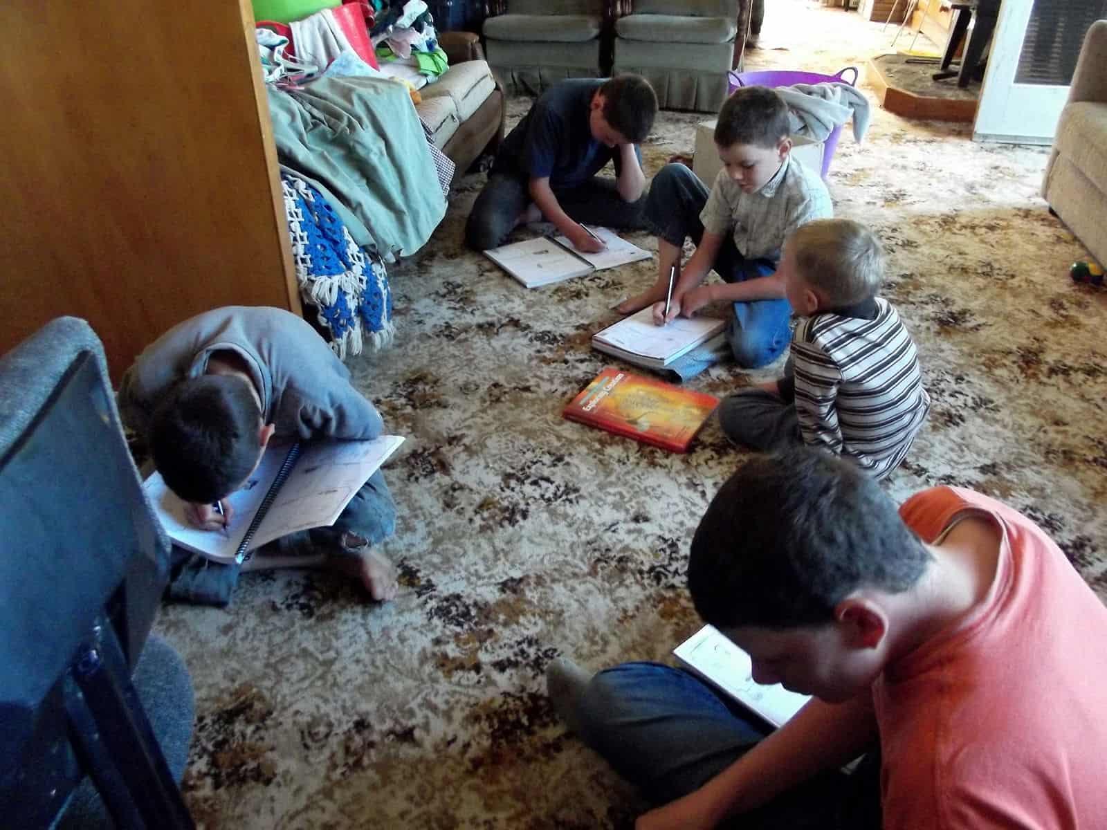 This is how we do science--all of us sit on the floor. I read aloud from the textbook, and then we work on filling in the notebooks.